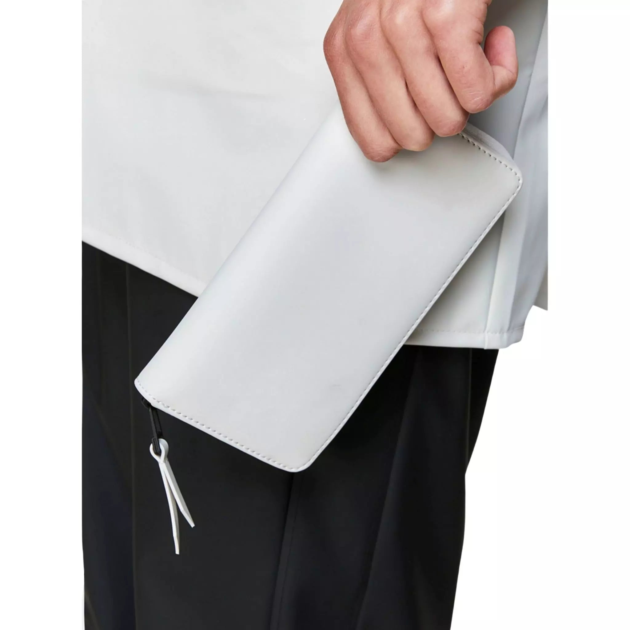 Rains waterproof wallet off white held by a man